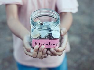 kid holding change jar